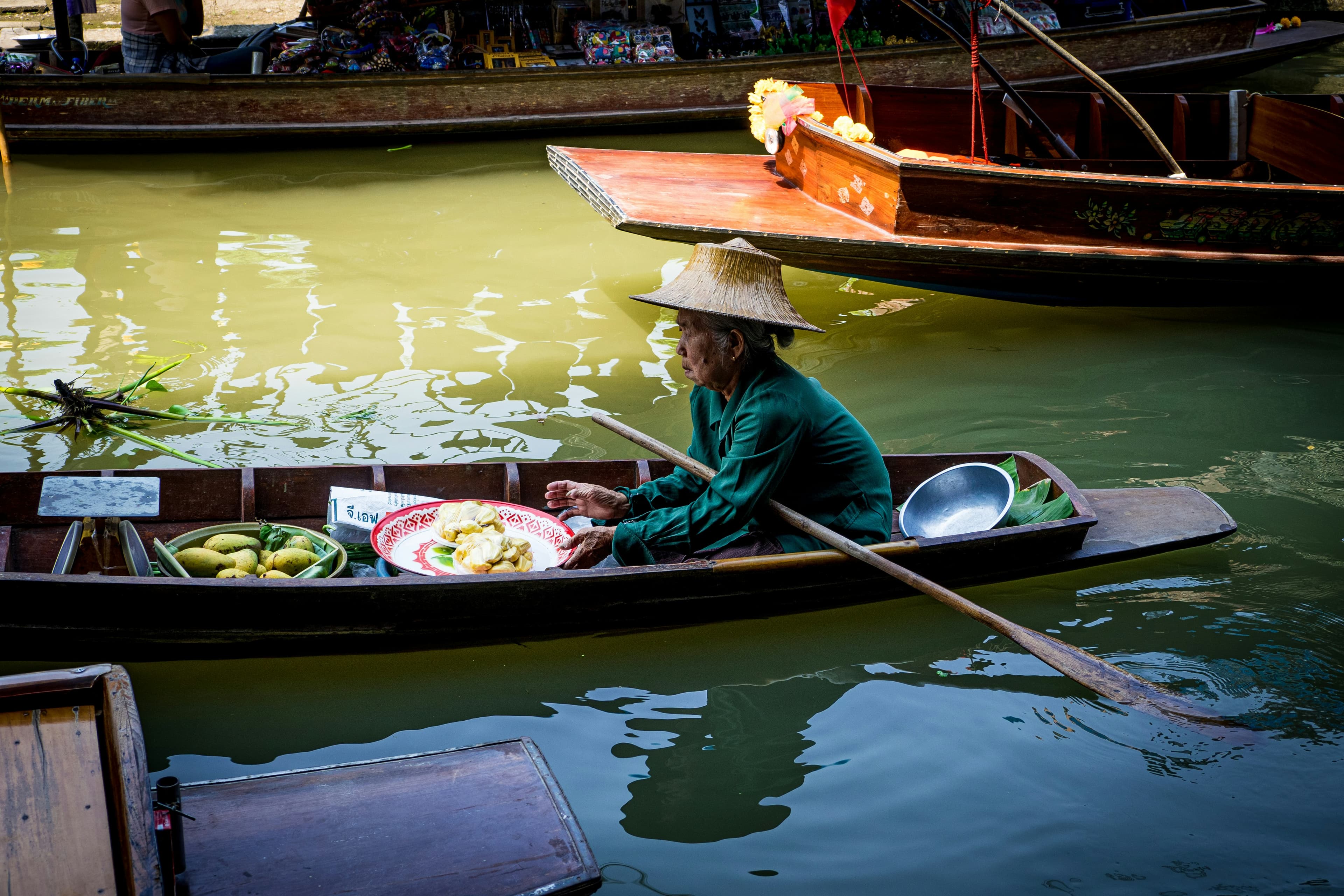 Woman selling food on a longboat