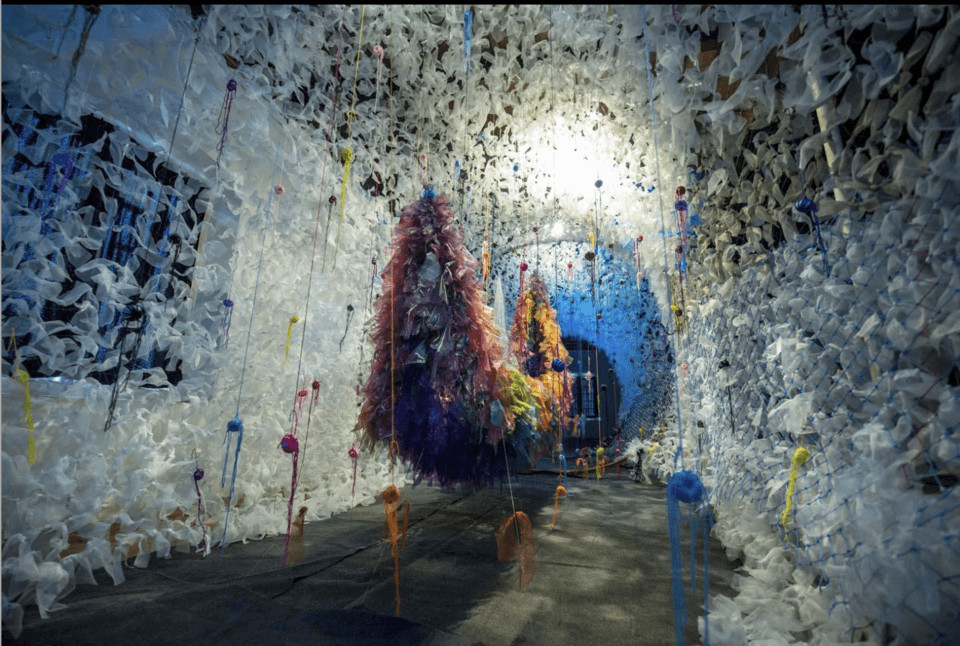 A boat made out of colourful feathers at Muziris Biennale