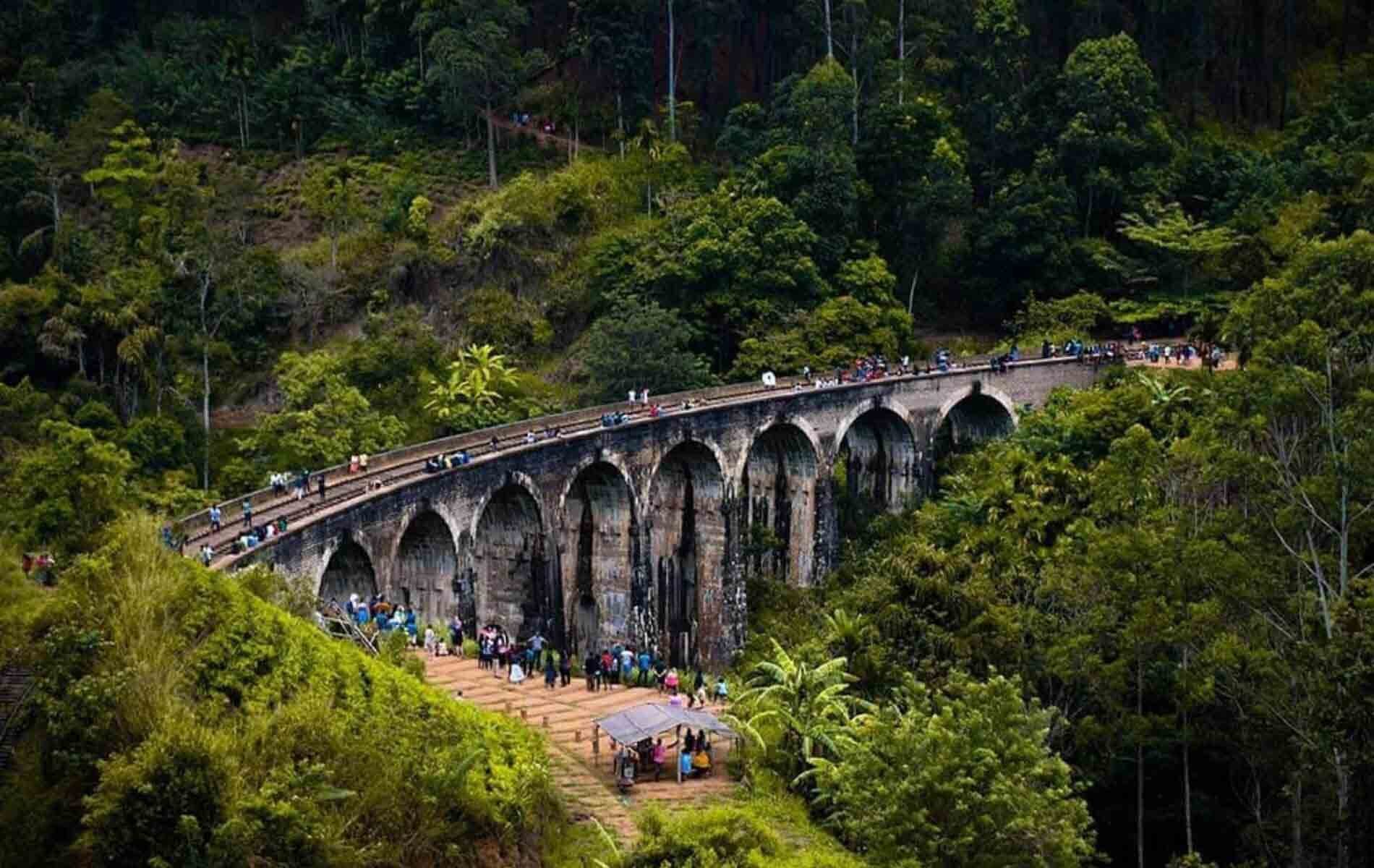 People taking pictures of the Nine Arches Bridge