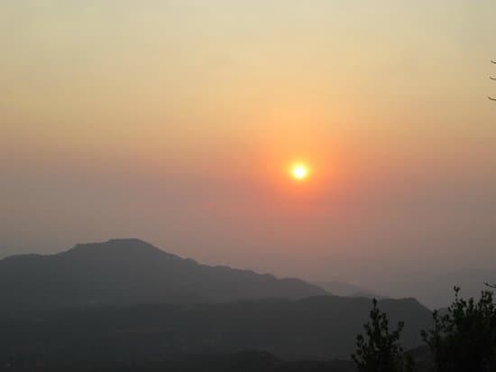 Mumbai Point sunset: Vibrant hues over lush landscapes