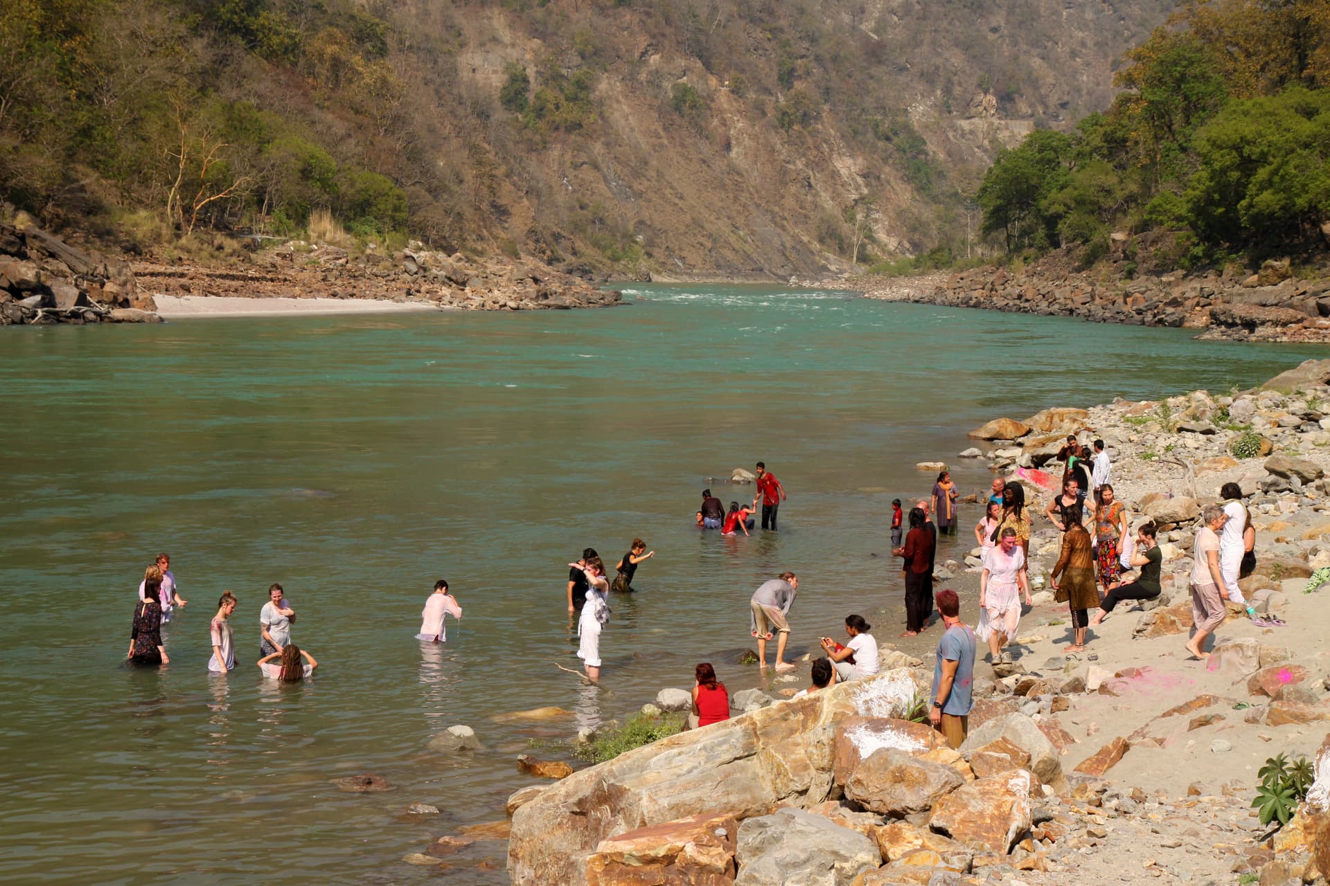 People taking a dip at the Ganga Beach