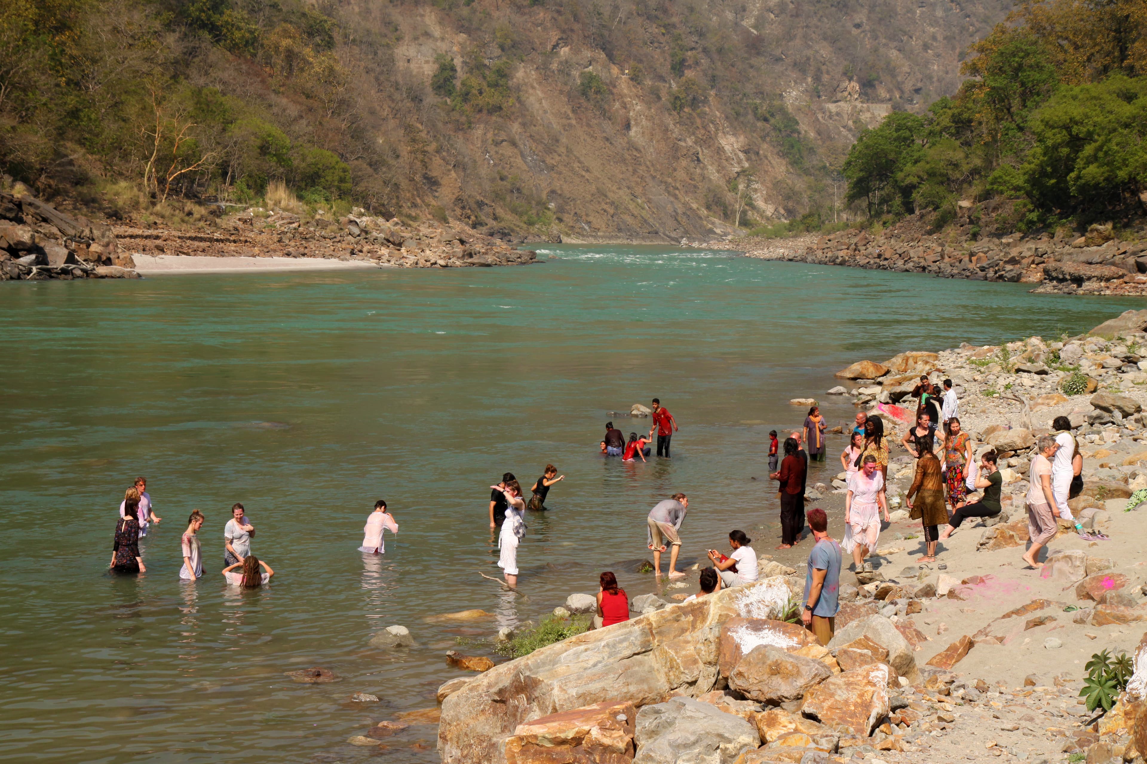 People taking a dip at the Ganga Beach