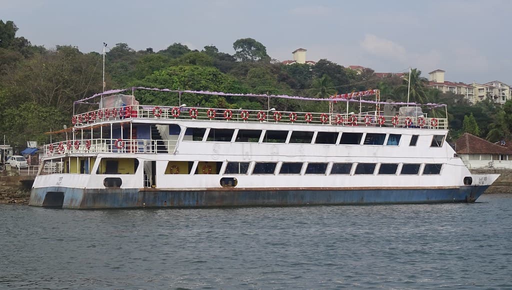 A boat gliding smoothly along the Mandovi River