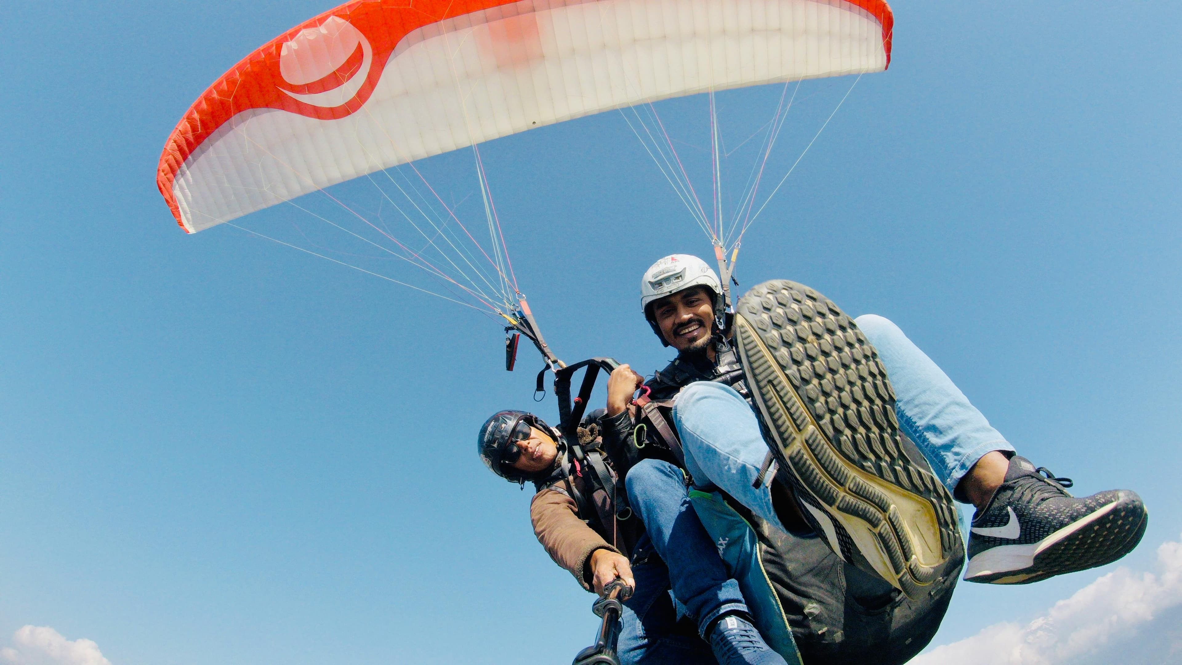 Tourists soaring high above Anjuna while paragliding