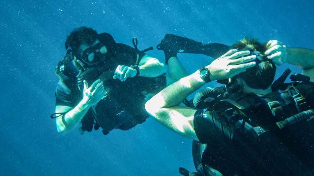 Underwater view of a diver near coral formations at Malvan