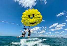 A tourist couple enjoying parasailing at Baga Beach