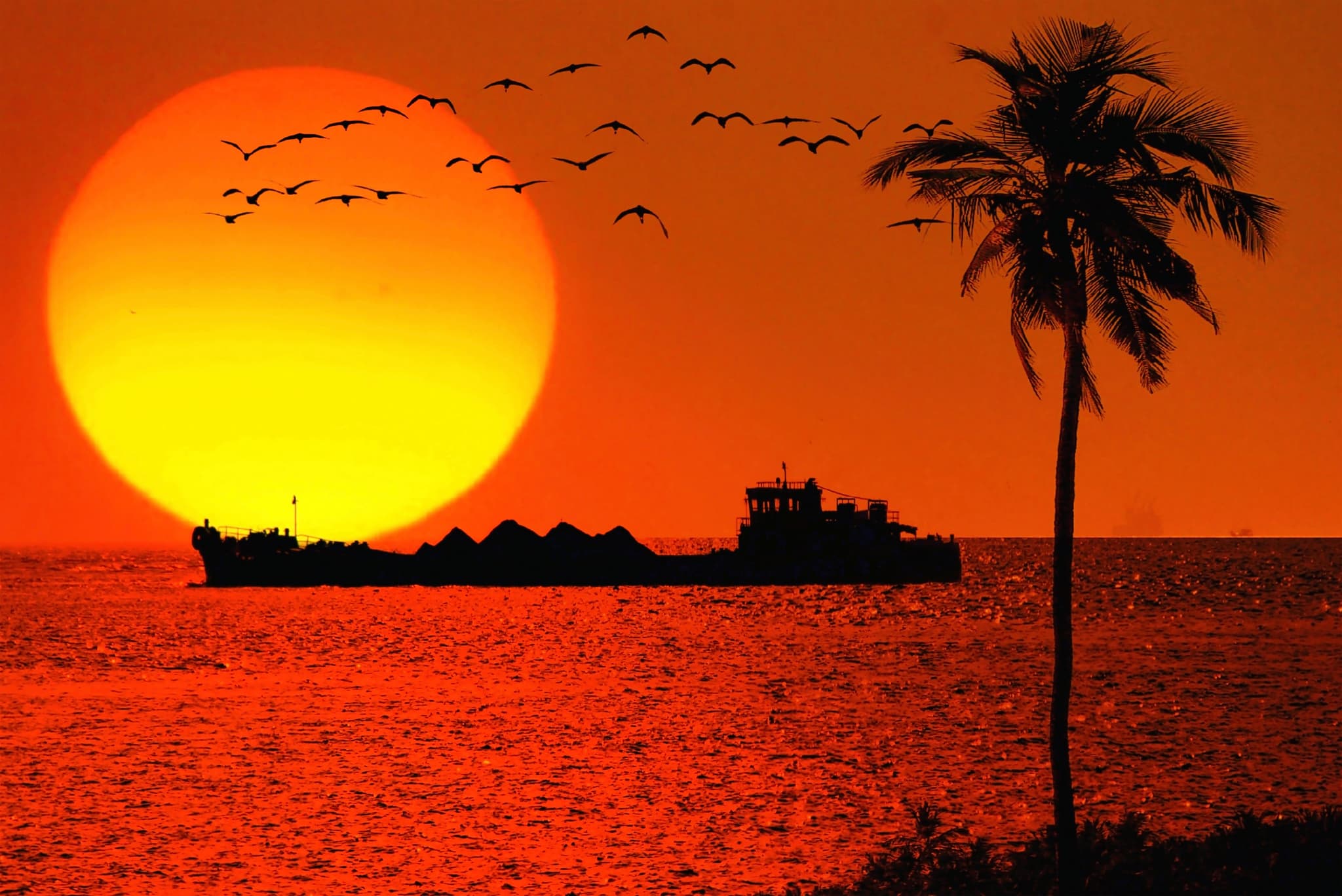 Ships sailing with a sunset background view in Goa Beach