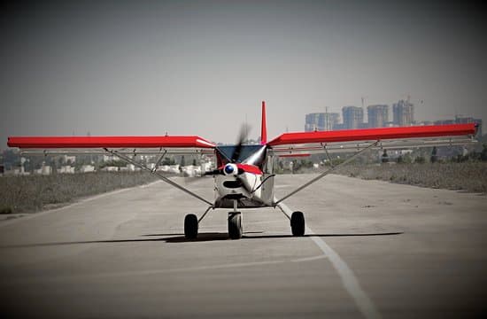 Microlight flying over open fields and hills near Bangalore