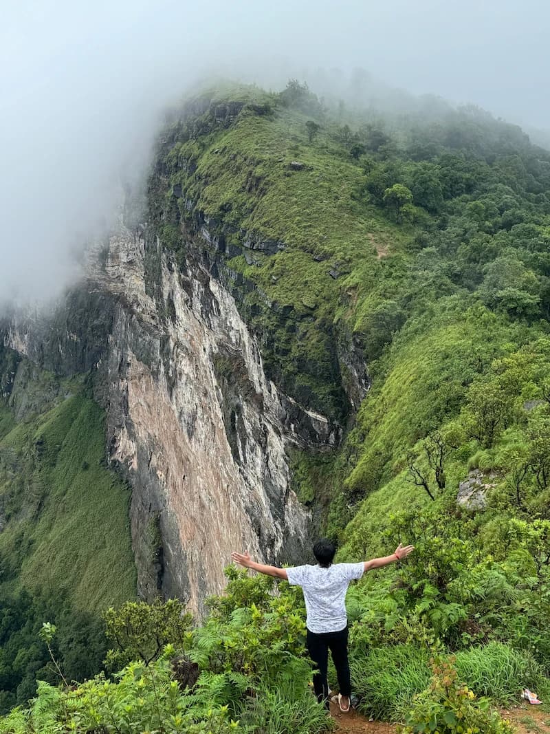 A visitor enjoying an amazing view of Bandaje Falls
