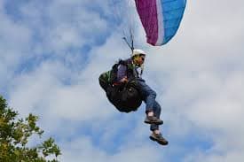 Soaring high while paragliding in Nandi Hills